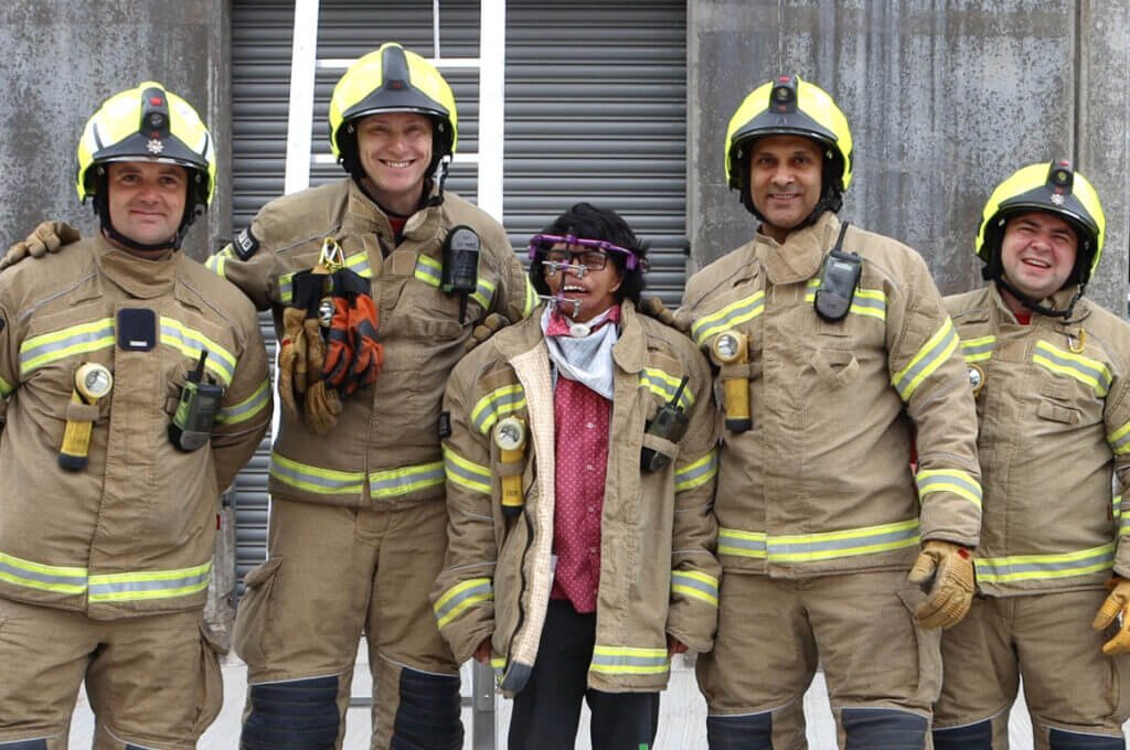 Ali with a group of firefighters